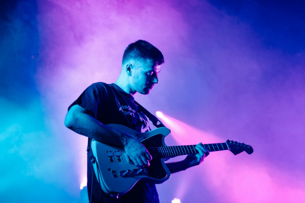 A man playing guitar at the best publicity firm in Los Angeles for celebrities
